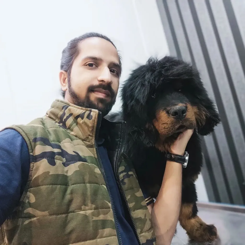 Dr Ahmad Ali Ch. posing with a Tibetan mastiff puppy.